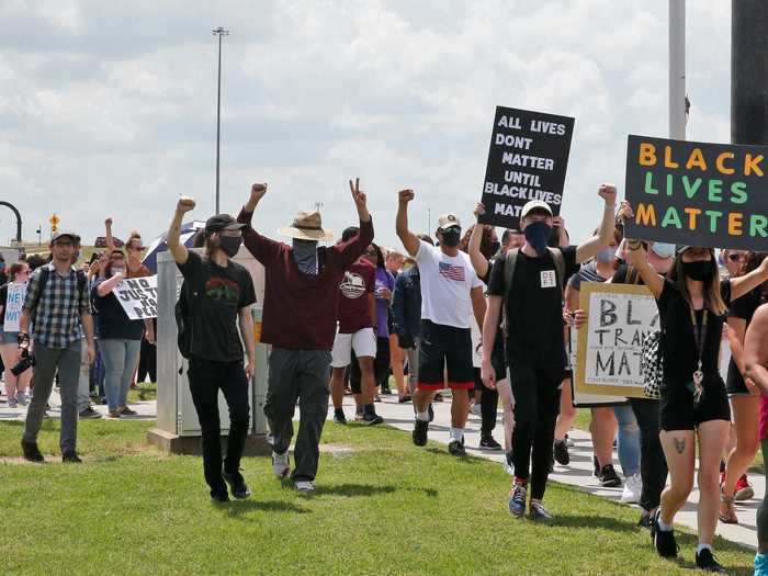 In Norman, Oklahoma, protesters march down the street toward the local police headquarters to demand justice for victims of police brutality.