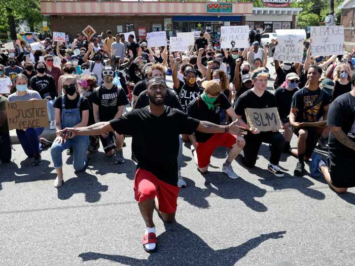 In Cleveland, Ohio, protesters are seen taking a collective knee to honor victims of police brutality.