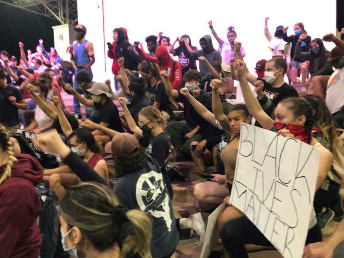 In Albuquerque, New Mexico, demonstrators sat for a moment of silence and collectively held up their fists.