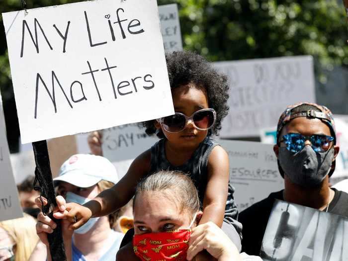 In Jackson, Mississippi, a 3-year-old is seen holding up a sign that says "My Life Matters," during a march through the city.