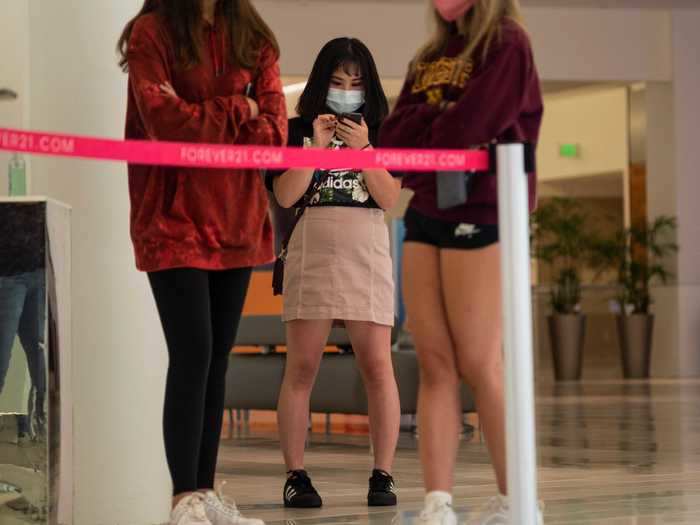 Entrances to stores are roped off as employees monitor how many people are in a store at a given time.