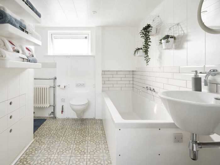 While bathrooms can be small, this modern bathroom features a finished tub and plenty of natural light.