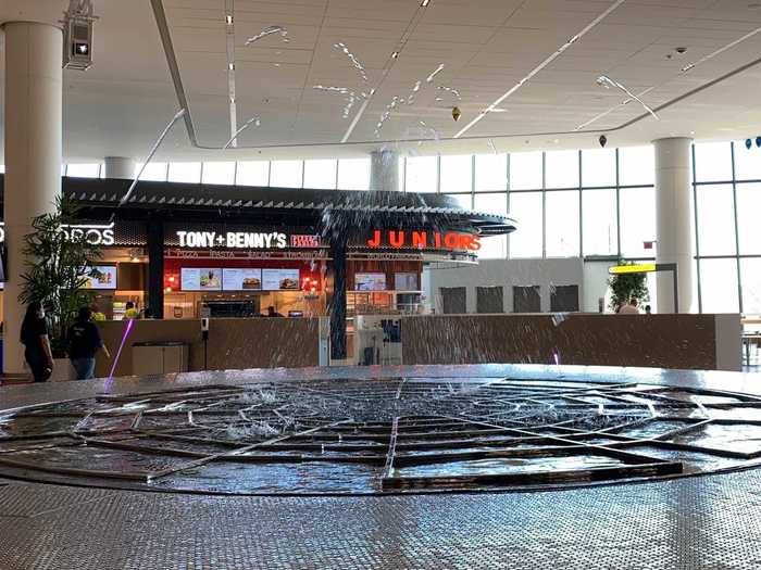 The feeling is like being in a luxury mall than an airport, especially as the centerpiece of this level is a water feature with LED lights creating a multi-color display.