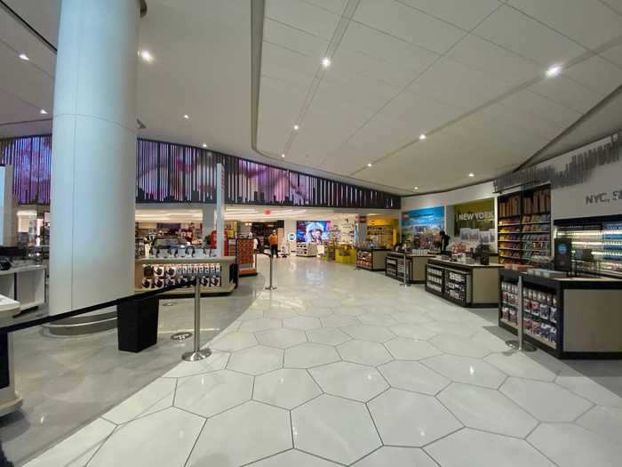 Before reaching the main lounge, passengers walk through the first retail space in the airport, just like how international airports have duty-free shops located just after security.