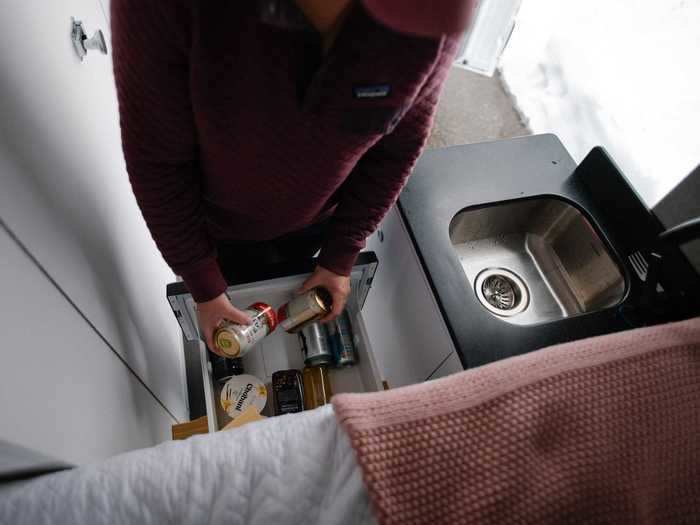 The interior kitchen space include a 30-liter refrigerator drawer, sink, and hidden trash bin.