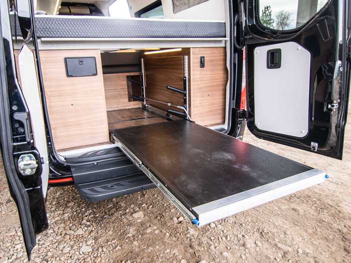The bed is raised to accommodate a garage — which includes a custom ski rack and a gear tray — underneath.