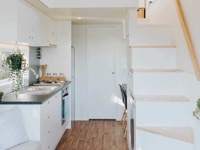 The door to the bathroom slides — instead of swings — out, saving space inside the tiny home.