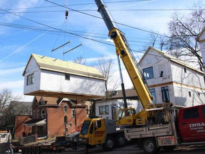 The foundations are laid down on-site, and the prefab homes are shipped in and lifted onto them.