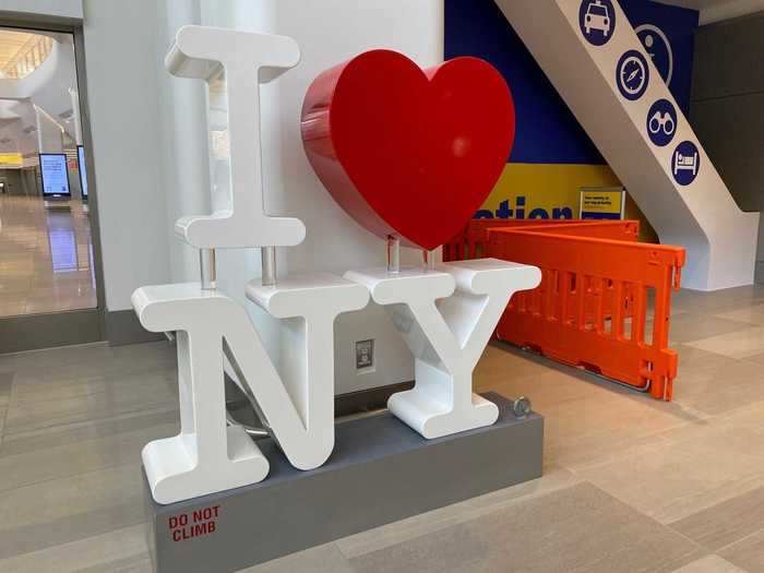 Multiple "I Heart New York" signs can be seen in the terminal.