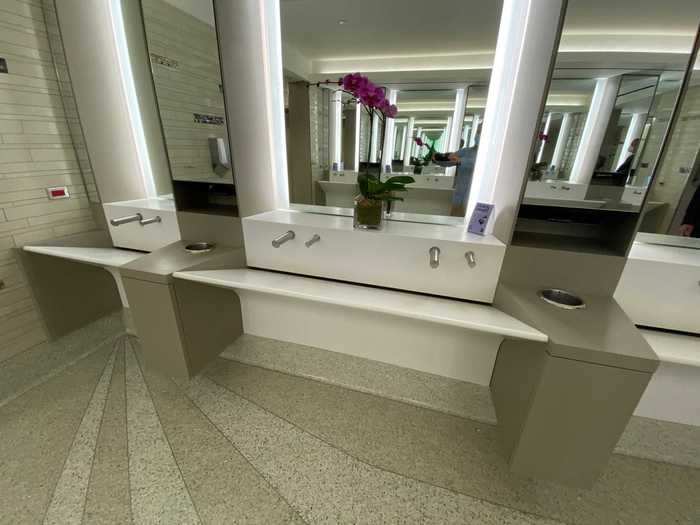 Each sink is designed with automatic faucets and counter space on top so passengers have a dry place to put their belongings.