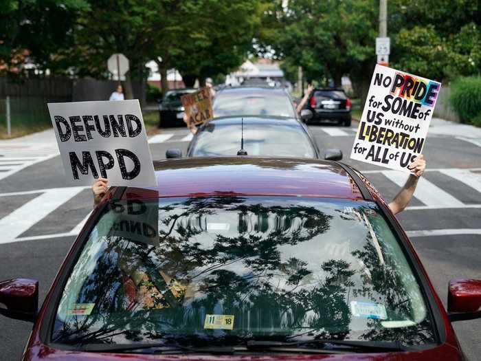 While in Silver Spring, Maryland, a line of cars followed behind a Pride march with signs reading "Defund MPD" and "No pride for some of us without liberation for all of us."