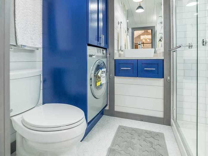 The bathroom also houses the washer and dryer.