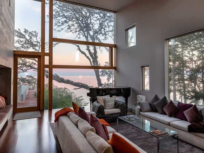 Floor-to-ceiling windows allow natural light to flood in, from the living areas ...