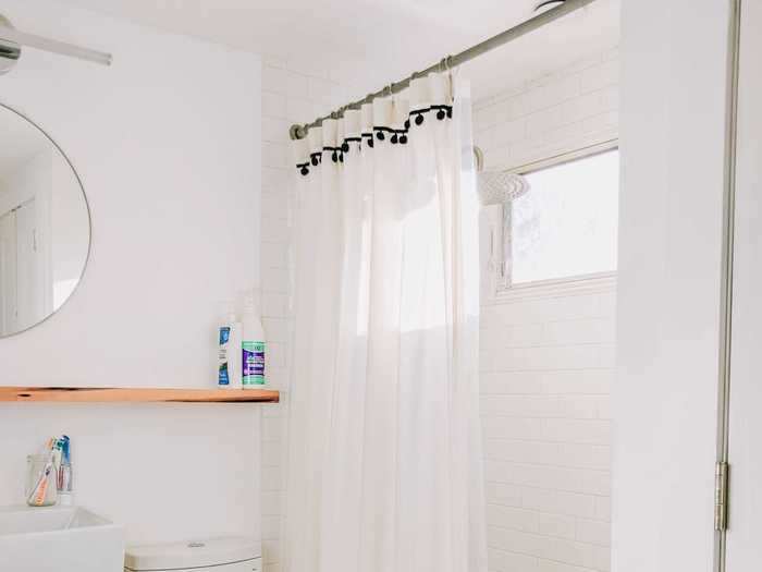 We made the bathroom larger by cutting into what used to be that weird blue bedroom, put down turquoise floor tiles, and installed a new toilet and sink. The wood frame and shelf were handmade by Tim.