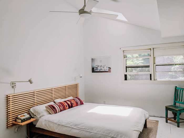 The other bedroom features the same simple bed frame, a different headboard that we also built ourselves, and a built-in closet.