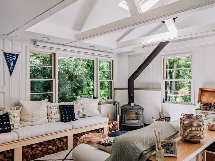 Tim designed and built a couch that goes from being wrapped around the dining table all the way to the fireplace. We had the white cushions custom-made on Etsy (disclaimer: he works there).