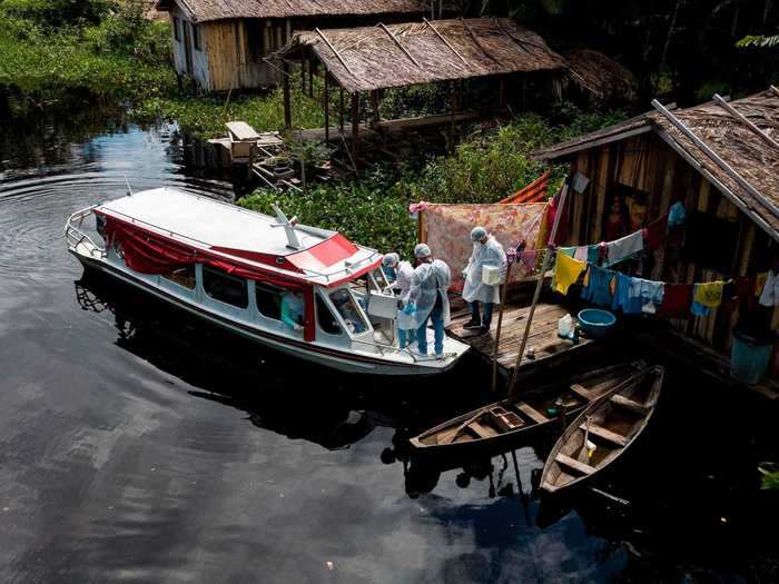 Here, healthcare workers are seen traveling by boat to riverside communities in the Marajoara region, located on the southwest island of Marajo at the mouth of the Amazon River.