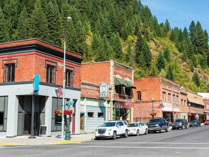 Historic brick shops in Wallace, Idaho, are offset by stunning mountain views.