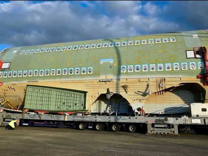 Photos of workers on the final project lined the fuselage, temporarily painted in green to protect the aluminum alloy.