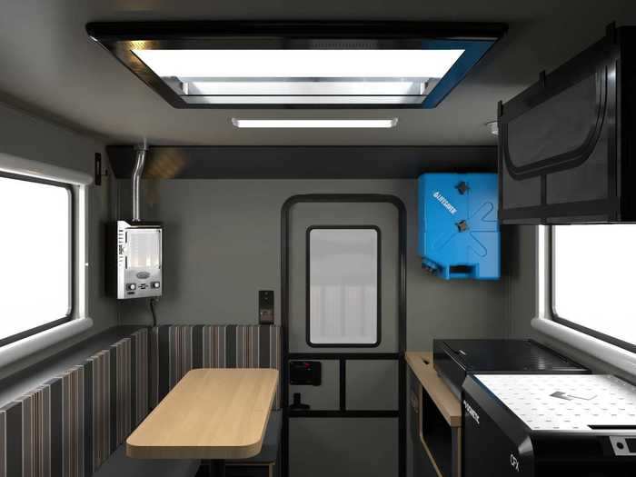 The tiny off-grid home on wheels includes a bed, dining area, and kitchenette-like space.