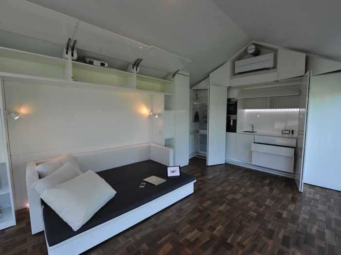 The small studio is designed with built-in furniture that uses the space efficiently.