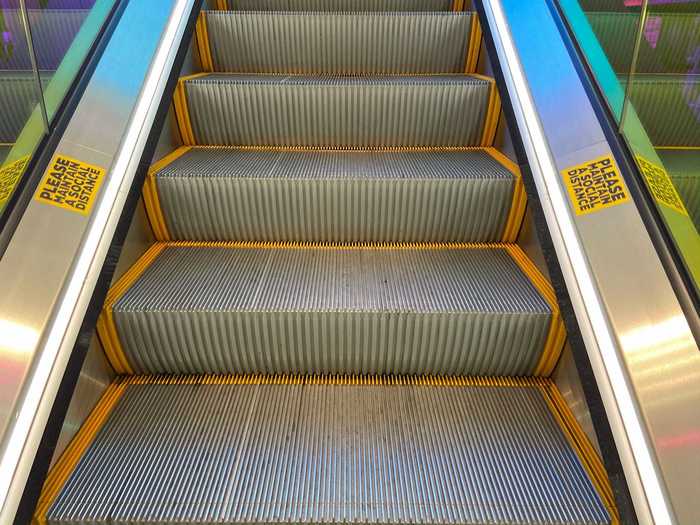 Stickers along the incline mark proper social distancing and provide shoppers with a visual cue for when to step on the escalator.