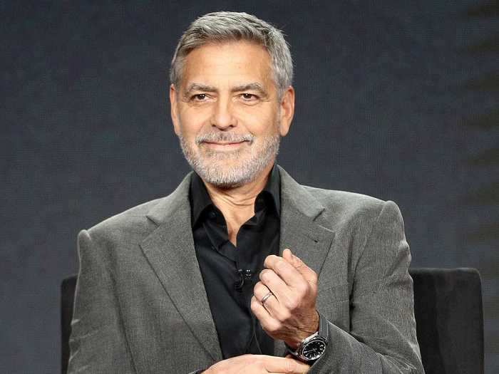 George Clooney has gray hair and a beard to match.