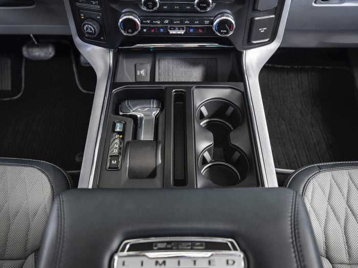 To make room for an interior work surface, something that many owners asked for, Ford developed a shifter that could fold away into a recessed area in the center console ...