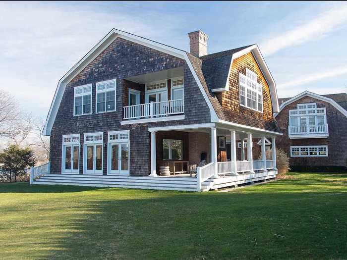 The covered porch is perfect for sipping cocktails by day ...