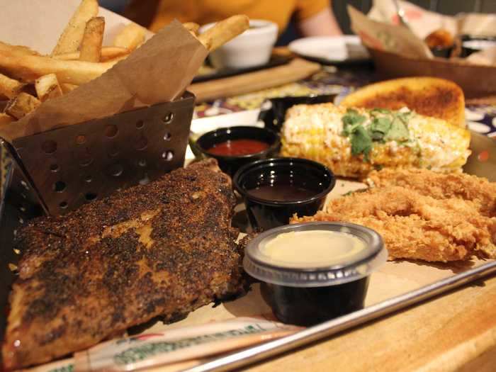 My meal also quickly came out and it was just as warm as the appetizers. I ordered the smokehouse combo with a half-rack of ribs, chicken crispers, roasted street corn, fries, chili-garlic toast, and dill pickle slices for $16.49.