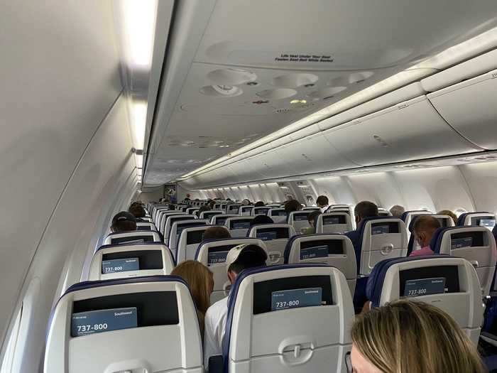 This flight was near to capacity but middle seats were not occupied unless a family was traveling together. Flight attendants continuously made announcements saying that a maximum of two people could sit in each row.