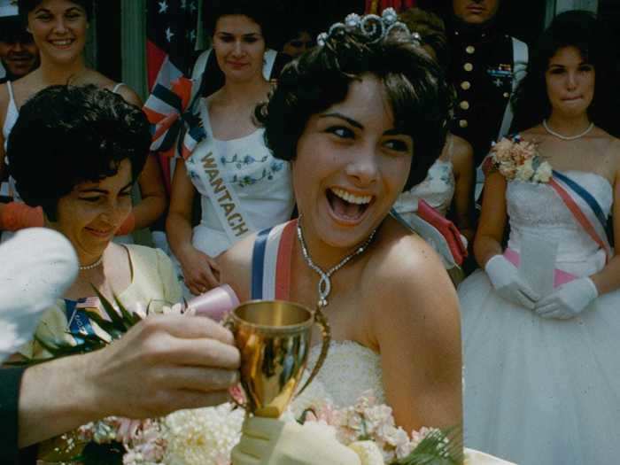 Pageants are another Independence Day tradition. In this photo, a newly crowned Miss Wantagh, Long Island, receives her trophy in 1961.