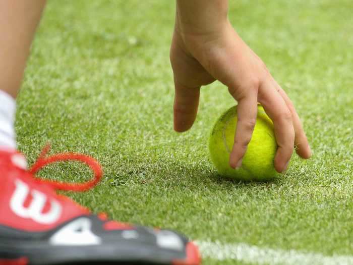 Tennis players are strongly discouraged from picking up tennis balls with their hands.