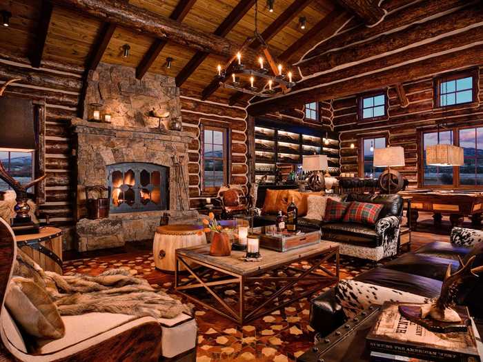 Inside the lodge is a large stone fireplace surrounded by leather couches ...