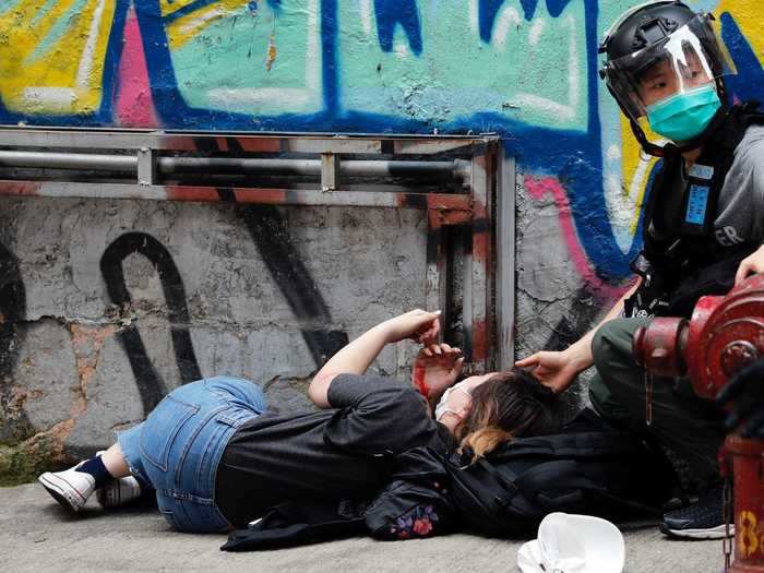 In this photo, a protester who was injured is seen being detained by police.