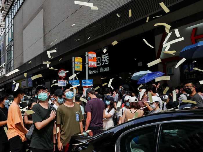 Demonstrators were seen throwing mock paper money into the air as they protested the new national security act.