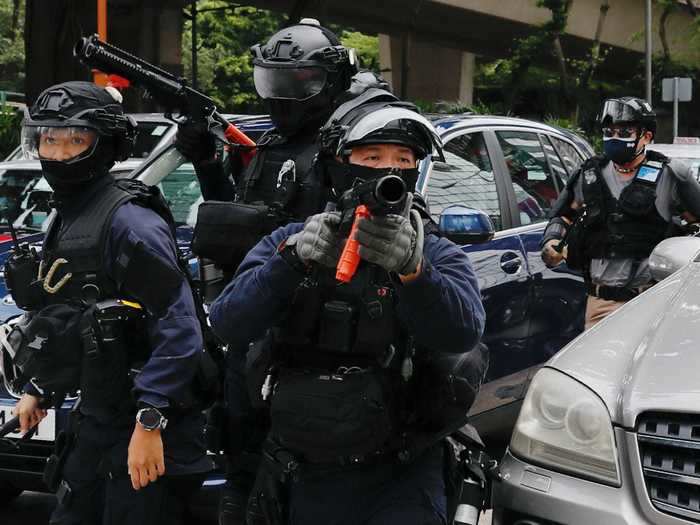 In this photo, Hong Kong police are seen targeting pepper spray projectiles at protesters.