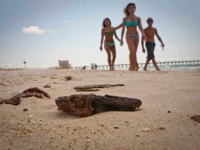 Hospitality and foodservice business leaders blamed press coverage of the spill featuring images like this one, of children walking on a beach dotted with tar, for keeping families away.