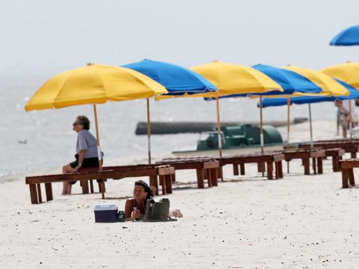 Once-packed beaches like the one pictured below in Biloxi, Mississippi, were empty for much of the summer of 2010.