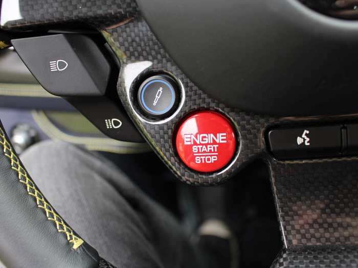 The famous red stop-start button, alongside the "bumpy road" button that adjusts the suspension for uneven terrain.