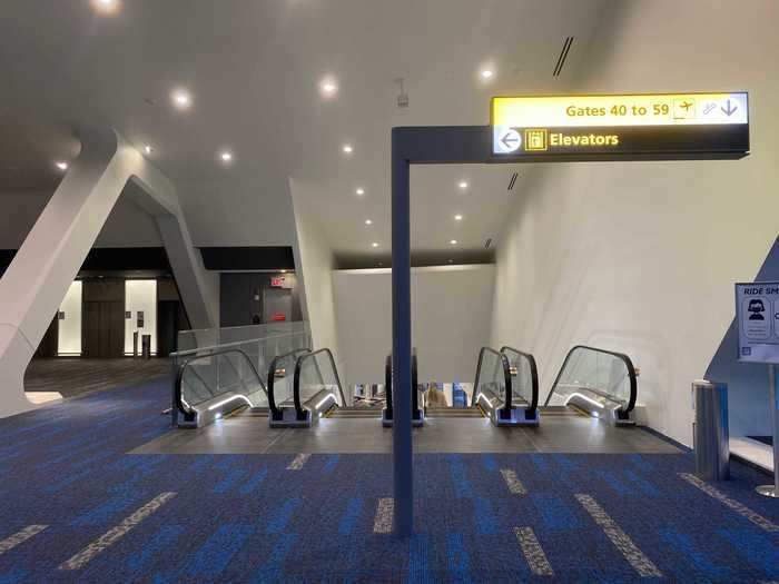 Passengers then descend into the terminal from above, going from the highest point of the terminal to the lowest.