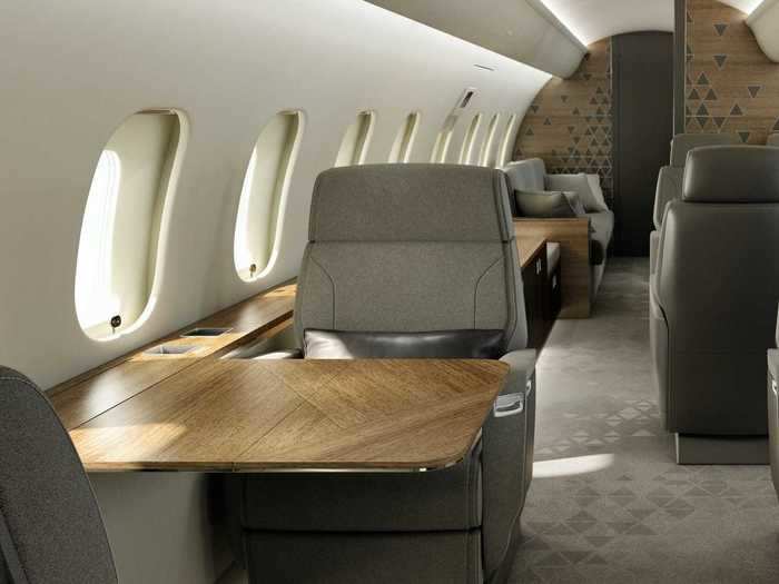 Each seat pair has a solid retractable table that is stored in the sidewall.