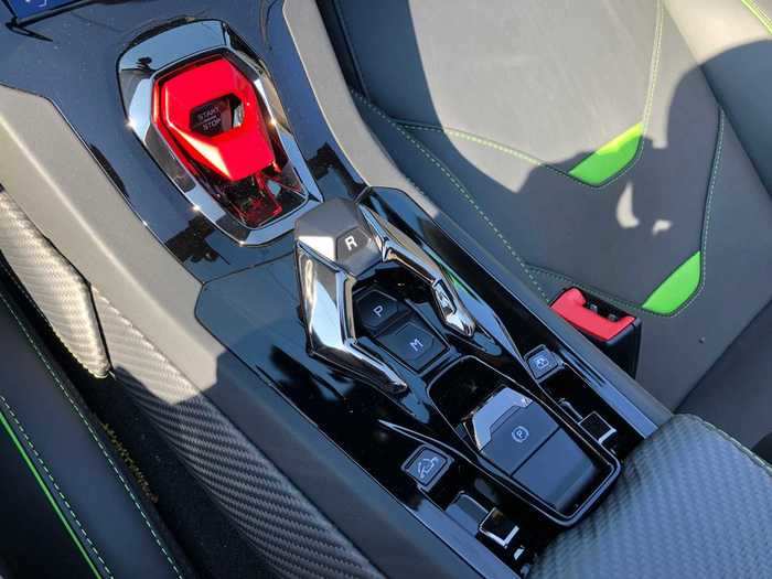 But the interior is crammed with cool, over-the-top elements, notably the fighter-plane-style flip-up red cover for the starter button and the throttle-like gearshift.