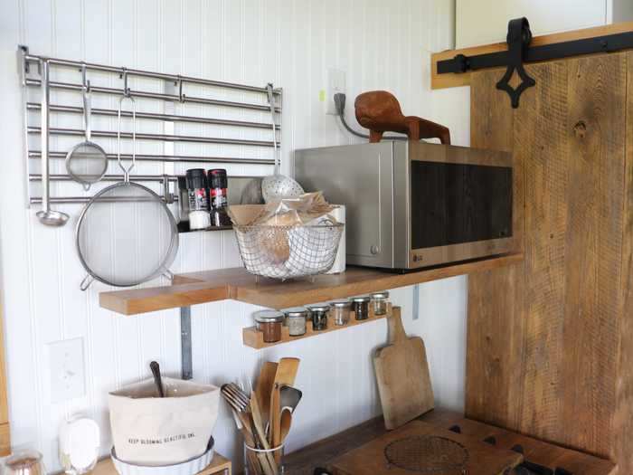 Shelving is also important in tiny homes so Gilley designed this cutting board-shaped shelf for her kitchen.