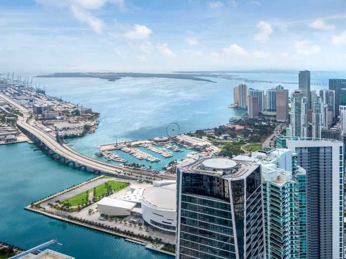 Located on the 50th floor, the condo is fully furnished and boasts sweeping views of Biscayne Bay as well as the city