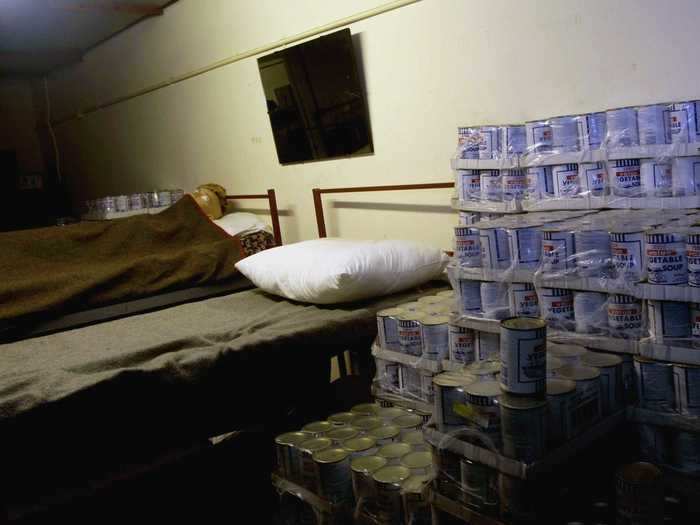 Another room shows a bedroom lined with cans.