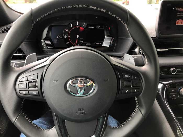 The leather wrapped steering wheel is the usual multifunction affair ...