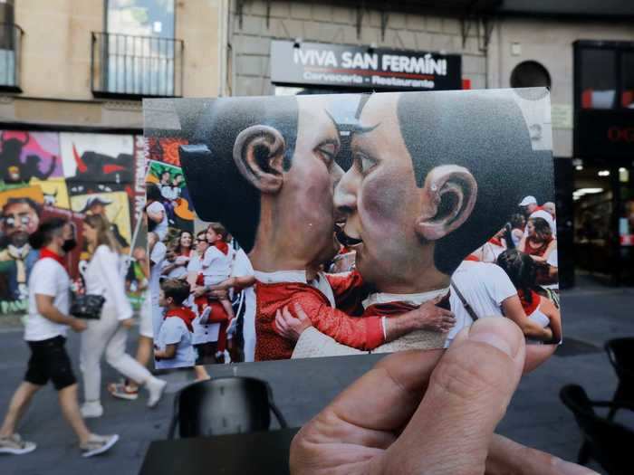 Here, two Cabezudos, or "Big Heads" are seen kissing during the procession.