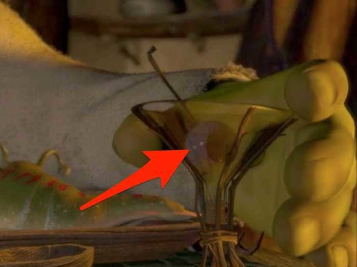 Shrek garnishes his drink with an eyeball.