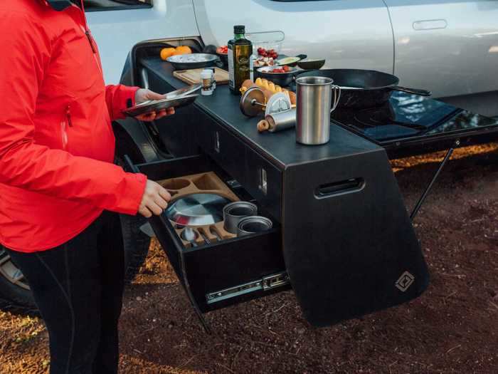 That tunnel can potentially be customized for lots of different purposes such as a slide-out camp kitchen, which Rivian showed off at the Overland West convention in 2019.